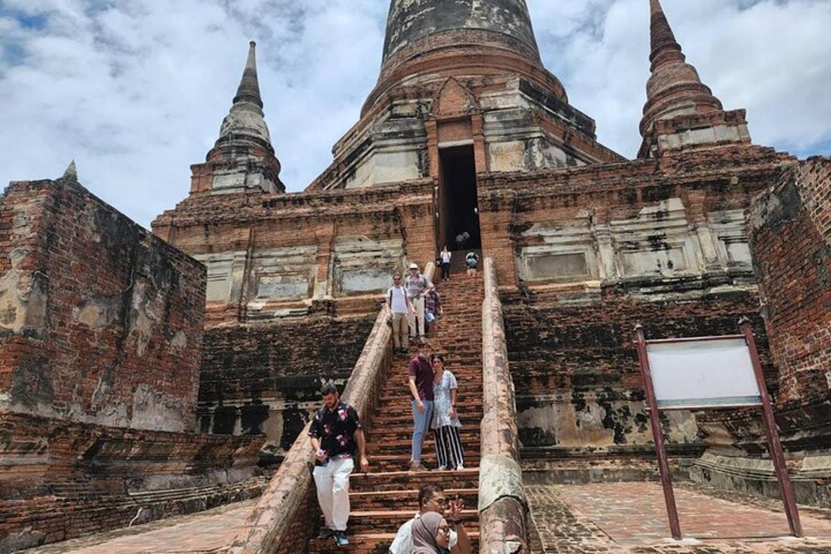 a group of people walking up the stairs of a temple