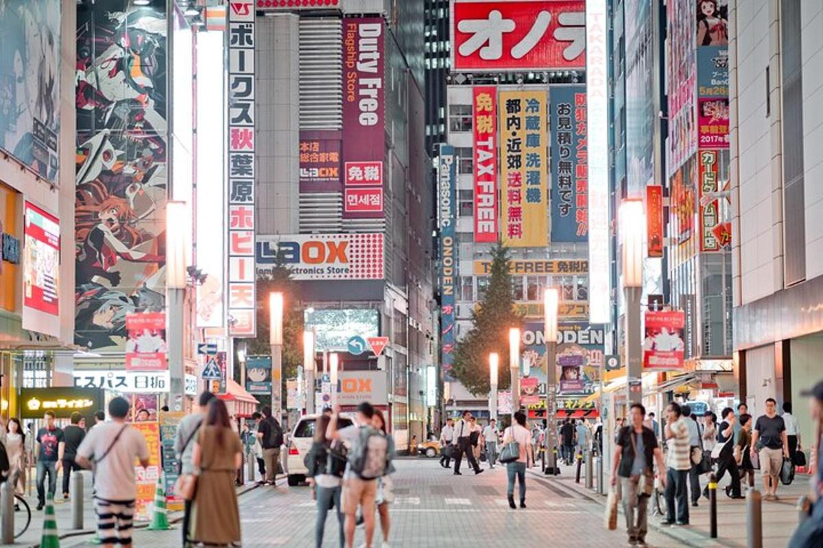 a crowd of people walking down a busy city street