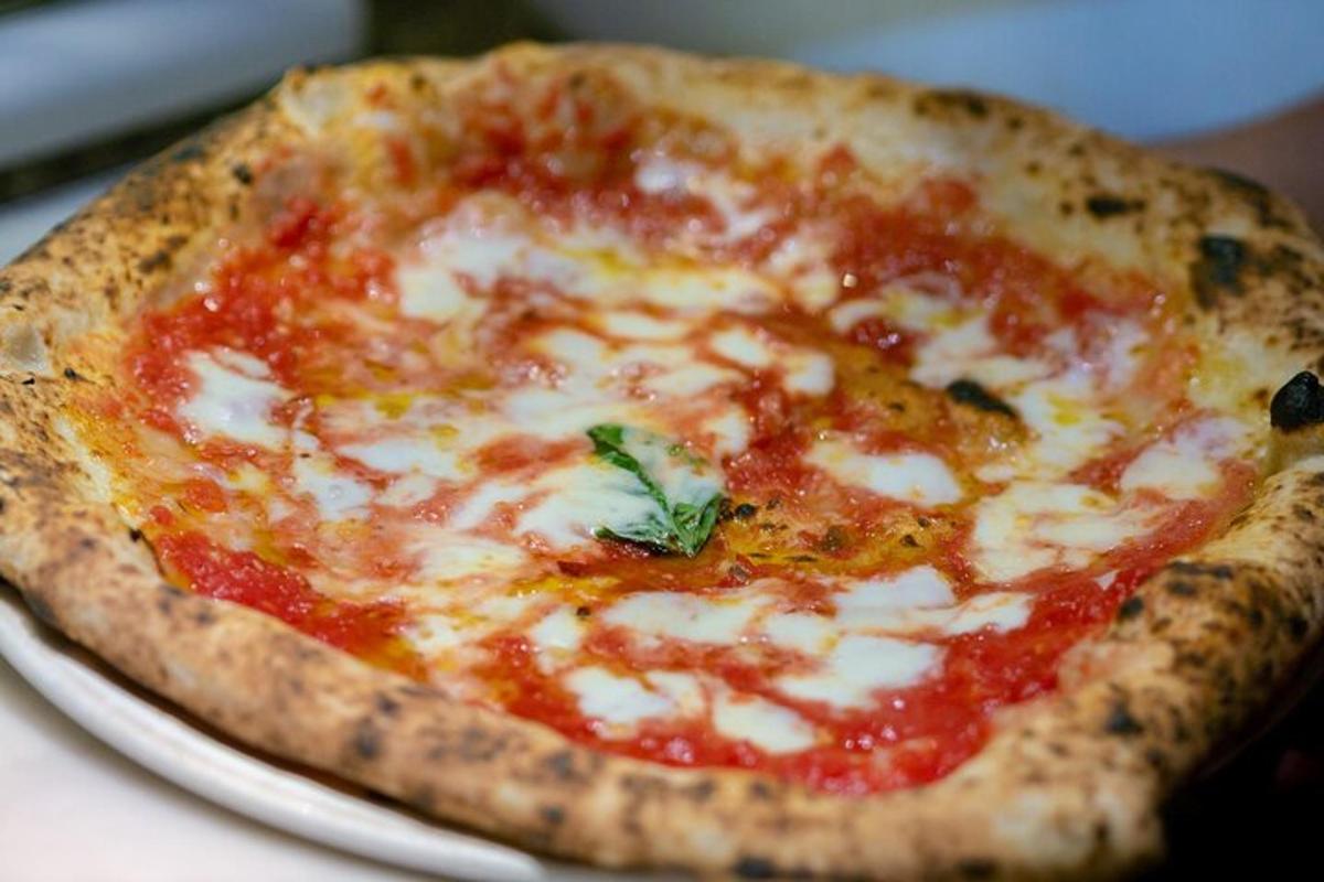 una pizza appoggiata su un piatto su un tavolo