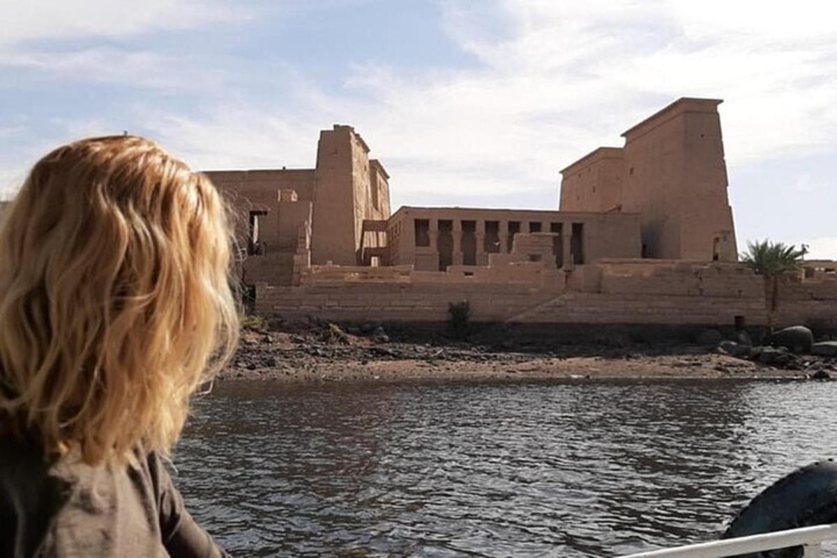 a woman sitting on a boat in front of a building