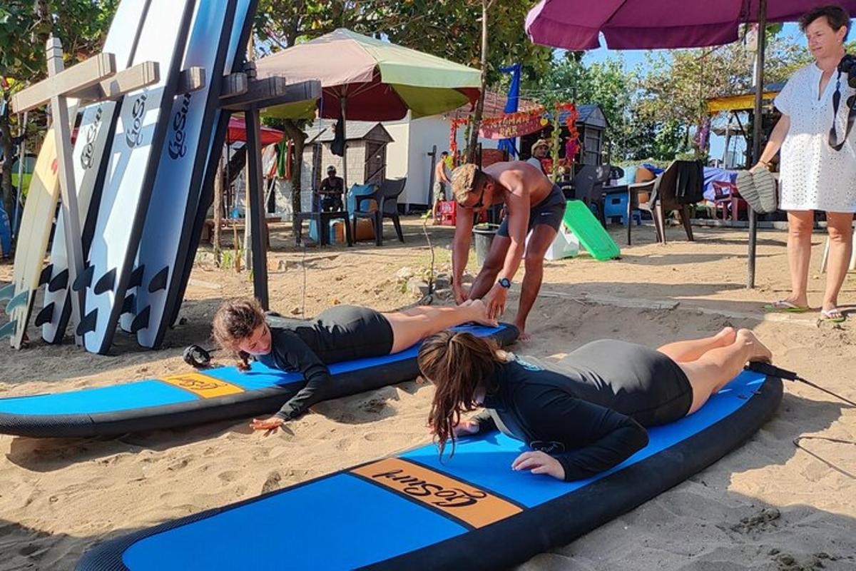 a group of people laying on surfboards on the beach