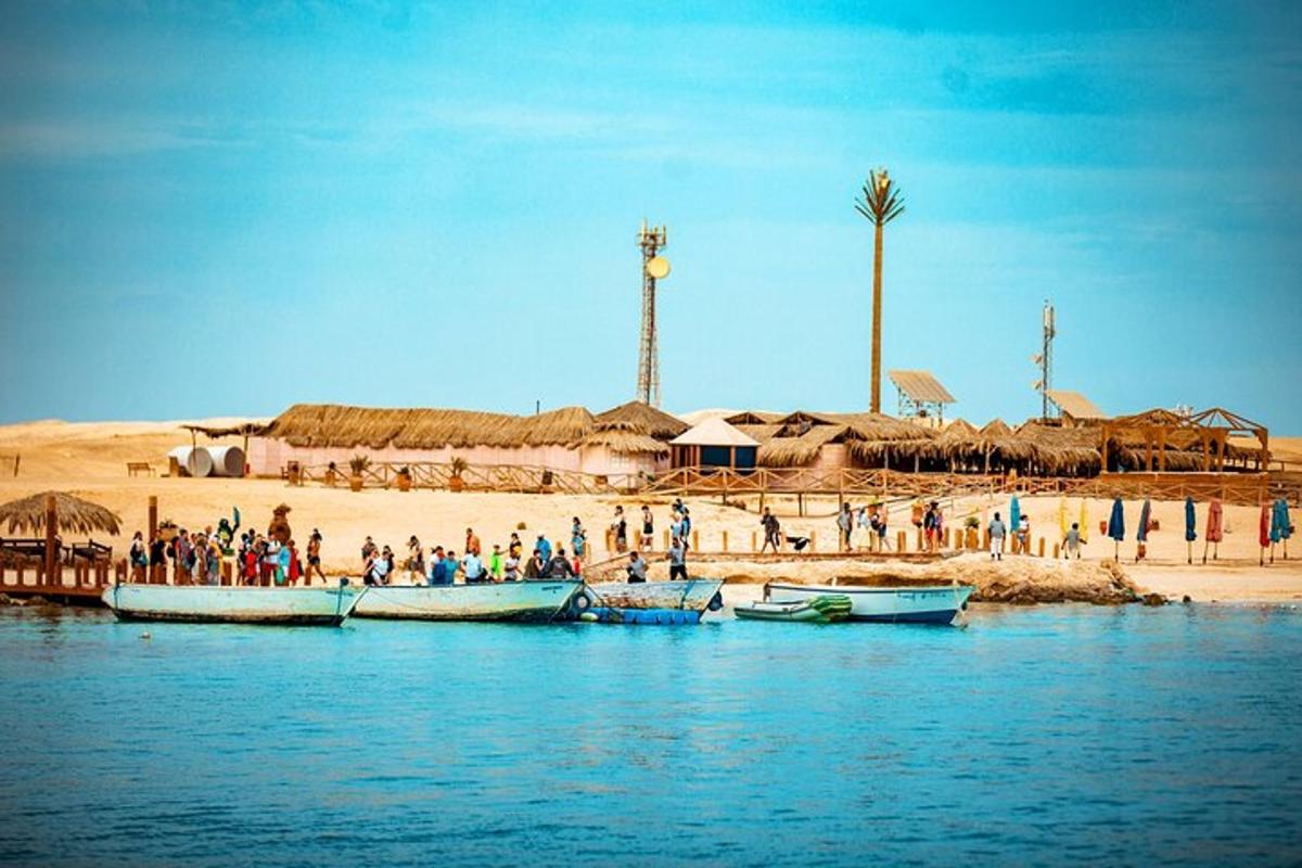 a group of people on a beach with boats in the water