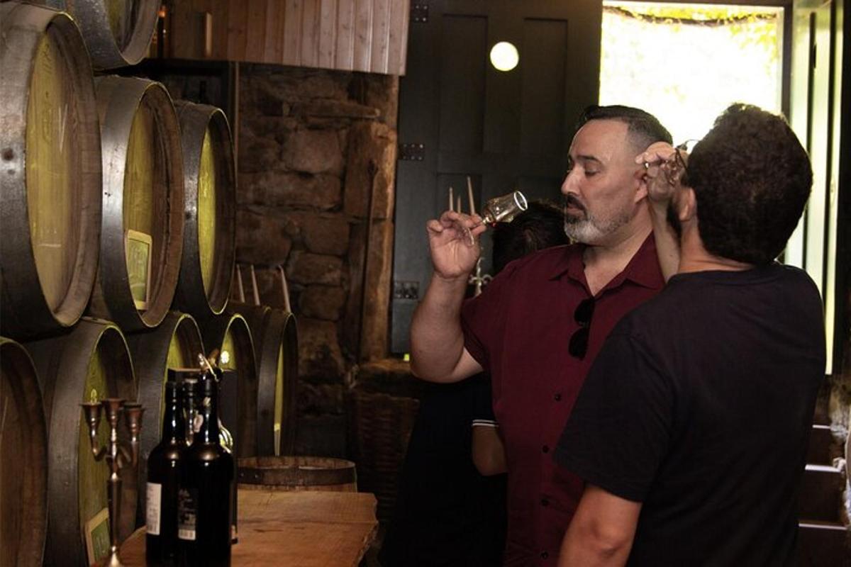 a man drinking a glass of wine next to a woman