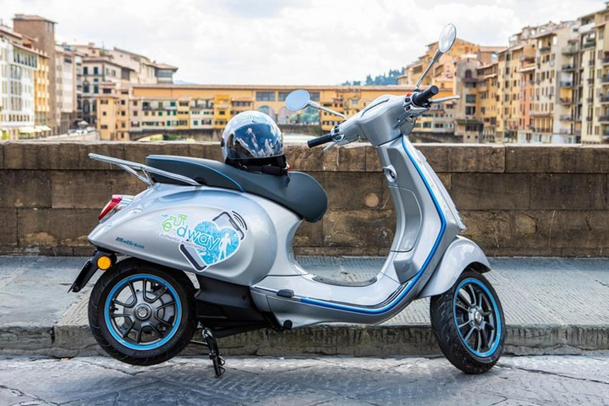 a silver scooter parked next to a wall