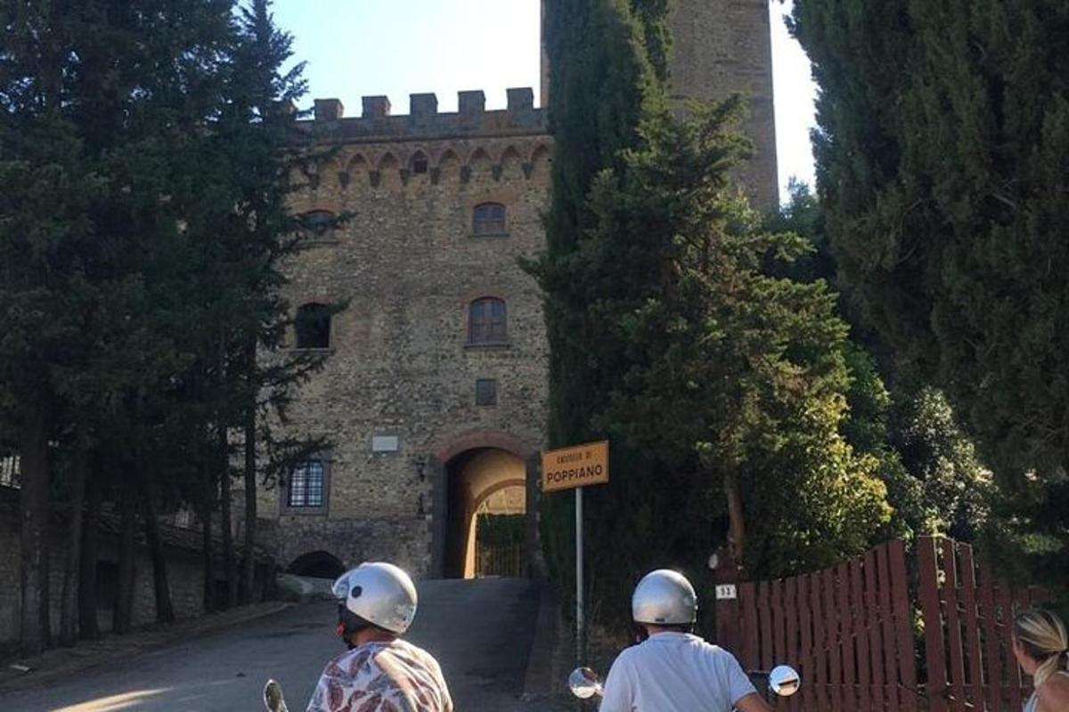two people riding motorcycles in front of a castle