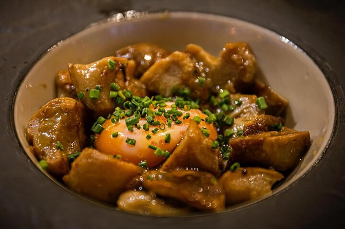 a bowl of food with meat and sauce