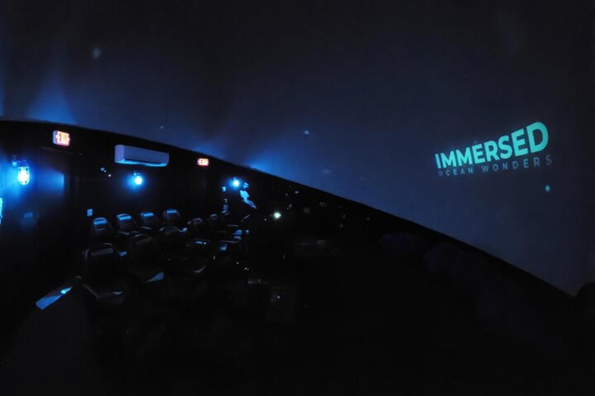 a stage with blue lights and a sign on it