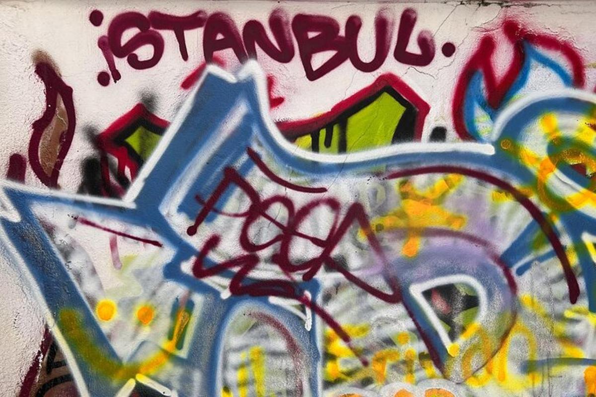 a wall with alot of graffiti on it