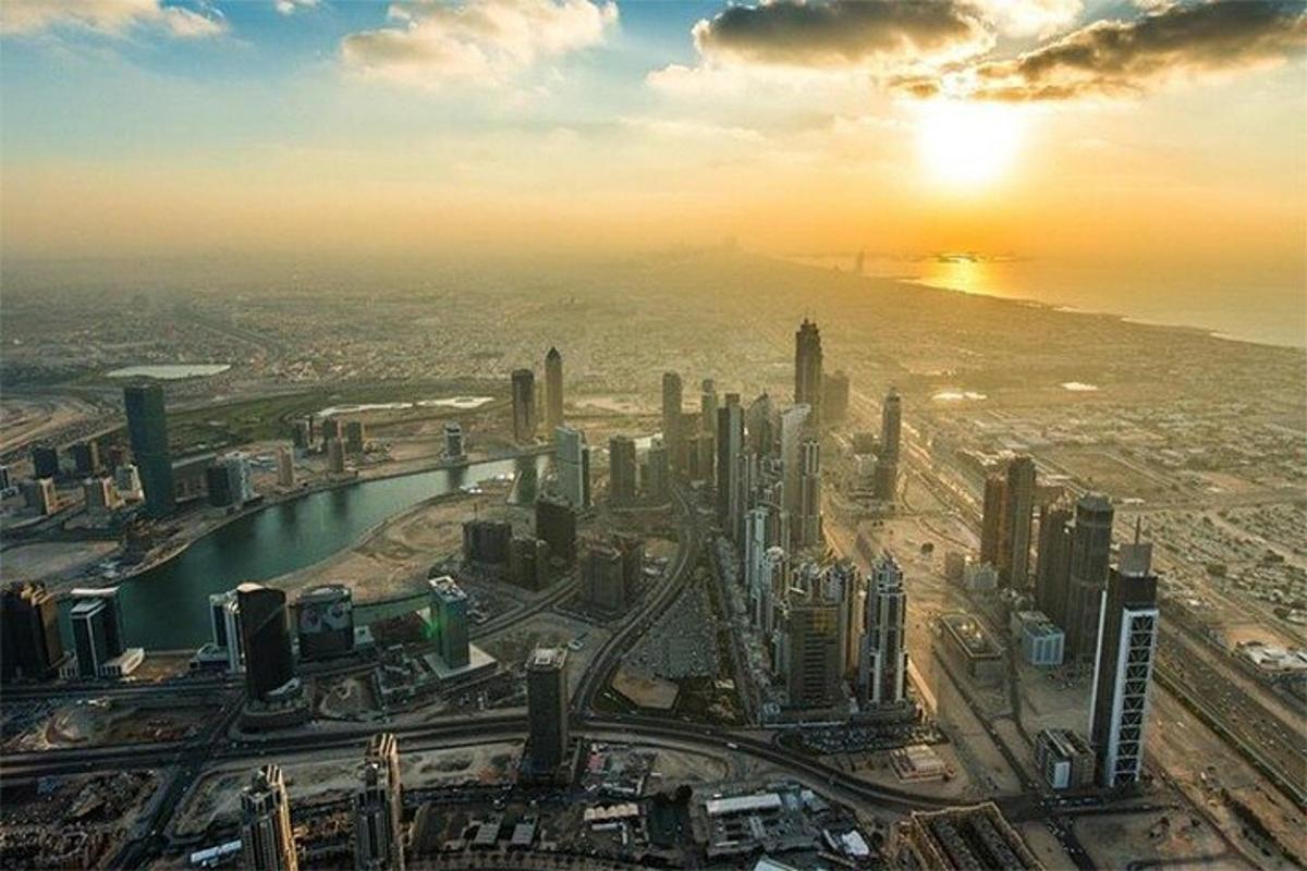 an aerial view of a city at sunset