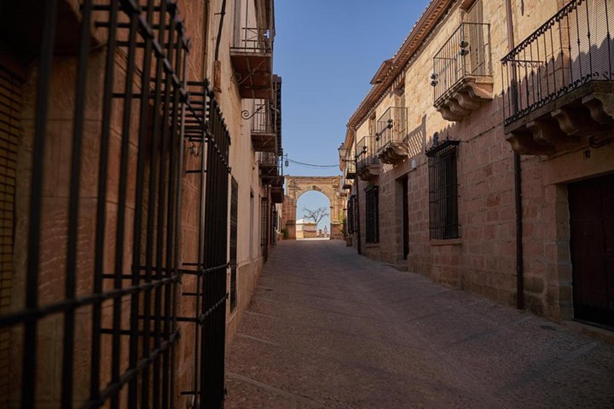 an empty alley with a bridge in the background