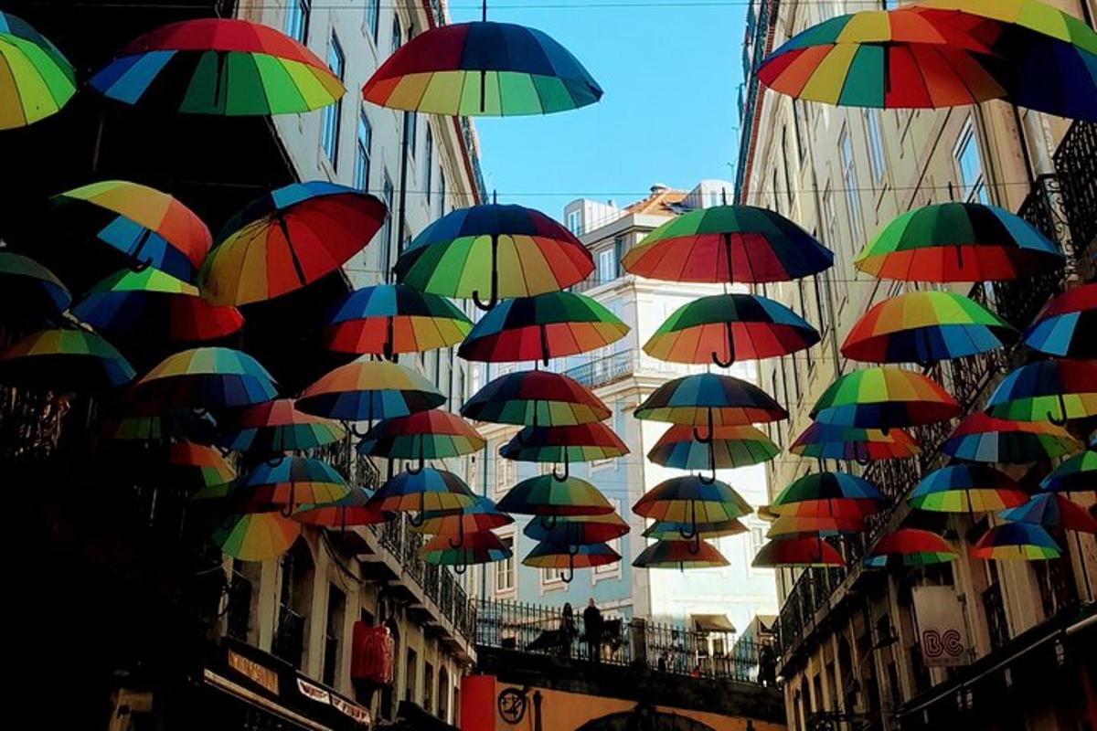 a bunch of colorful umbrellas hanging from a building