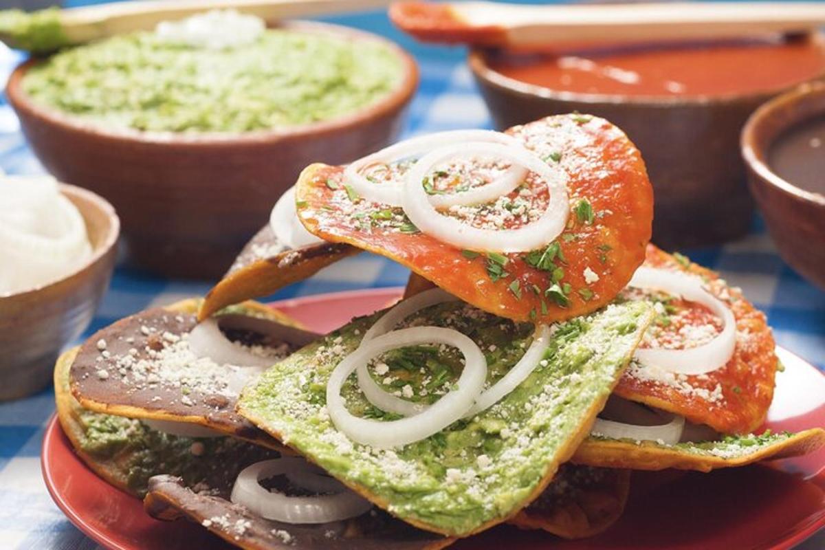 a red plate with a sandwich with onions on it