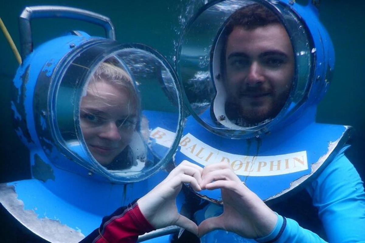 a man and a woman are making a heart gesture in front of mirrors