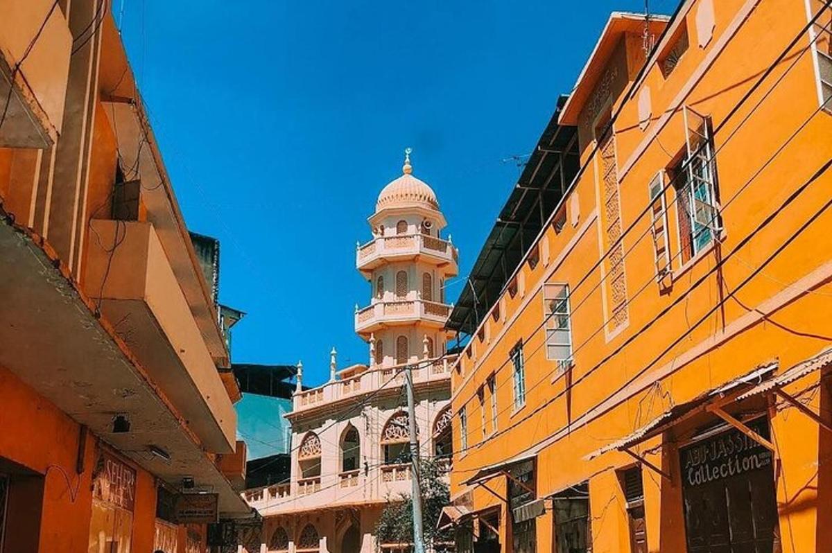 a building with a tower in the middle of a street