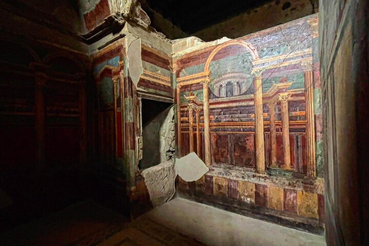 a room with a painting on the side of a building