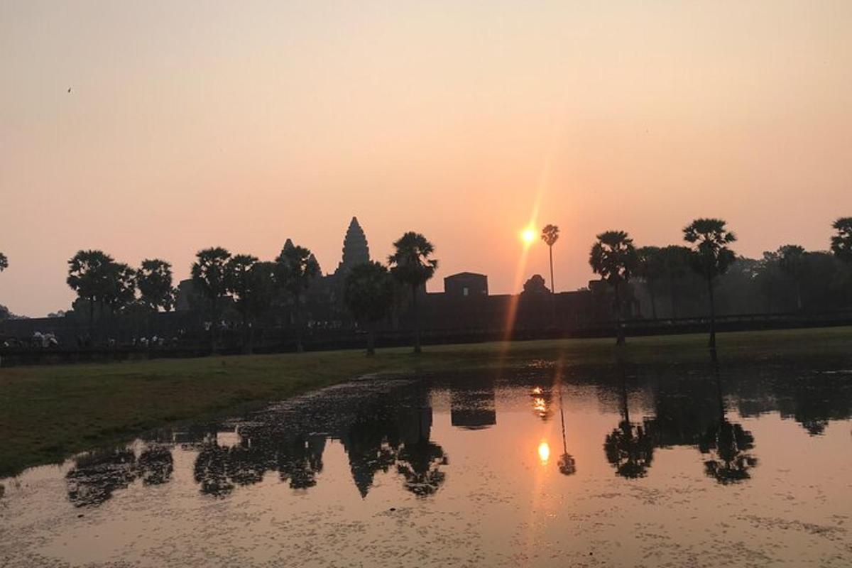 夕阳西下，水面上，背景是一座寺庙