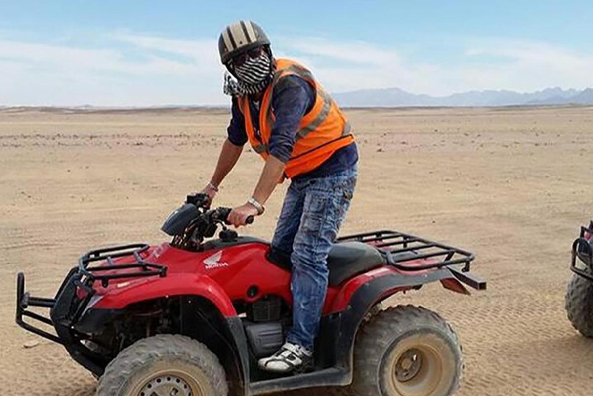 a man on a atv in the desert