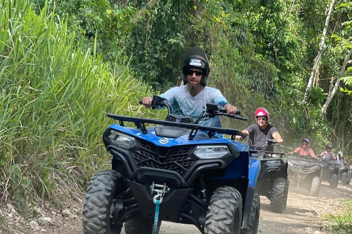 a man riding on a four wheeler on a trail