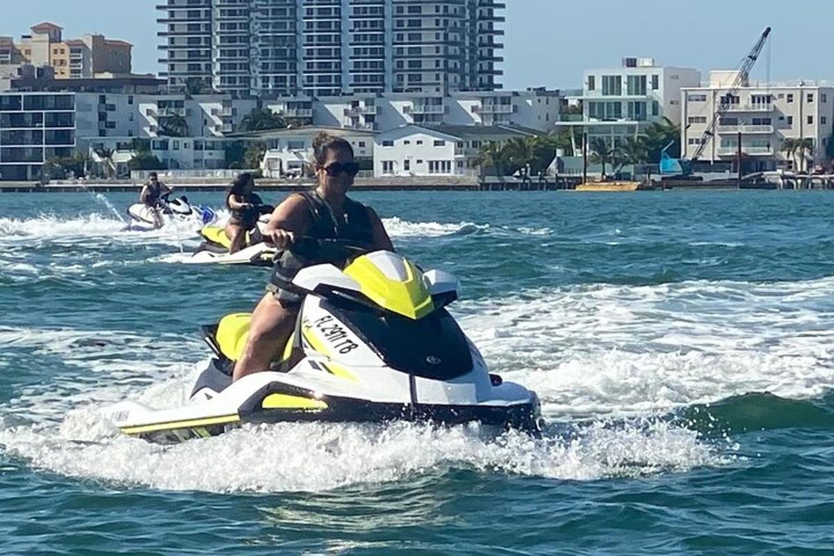 two people riding on a jet ski in the water