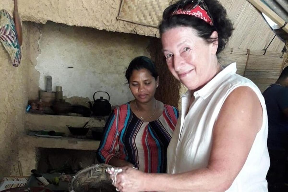 a woman standing next to a woman in a kitchen