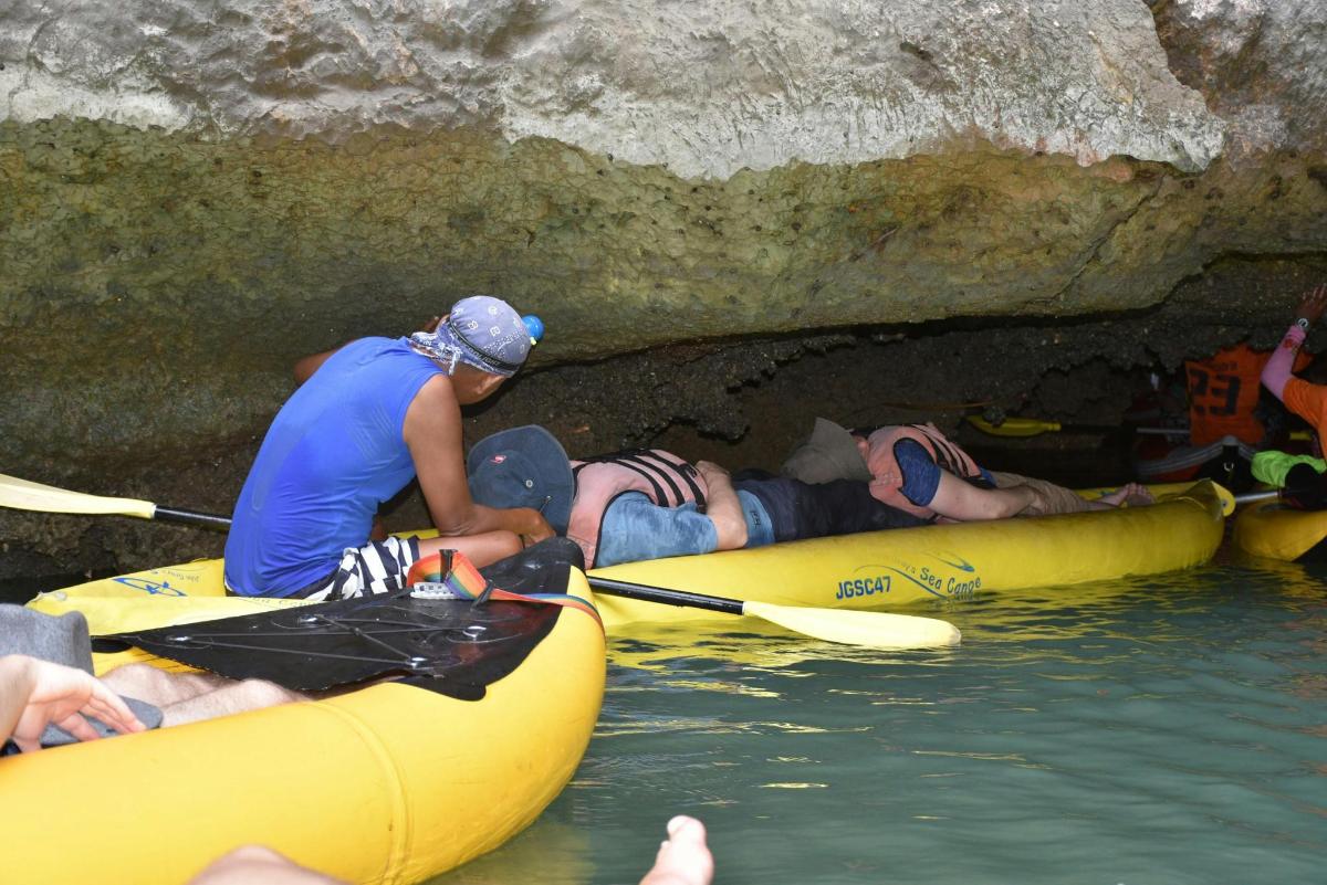 a group of people in kayaks in a cave