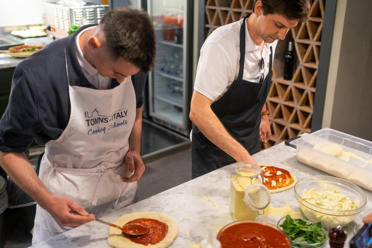 two men in a kitchen preparing food on a counter