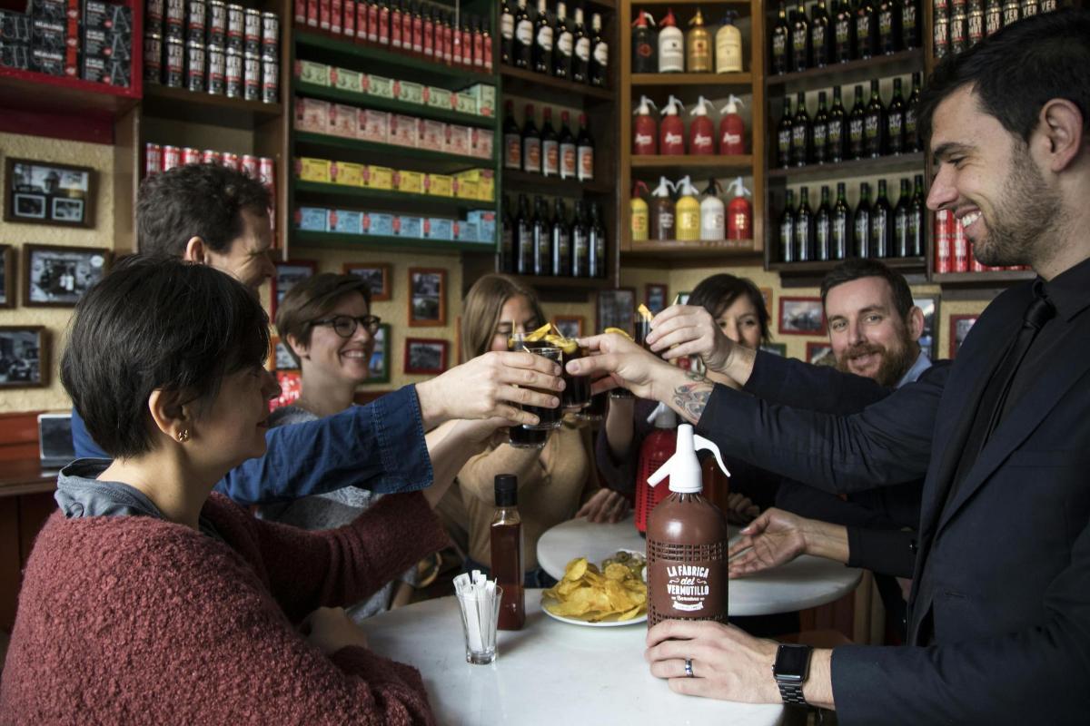 a group of people drinking at a table in a bar