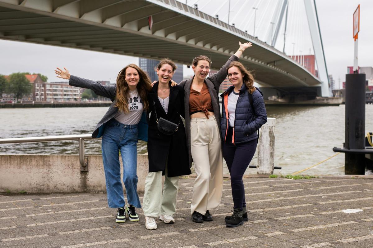 a group of people standing in front of a bridge
