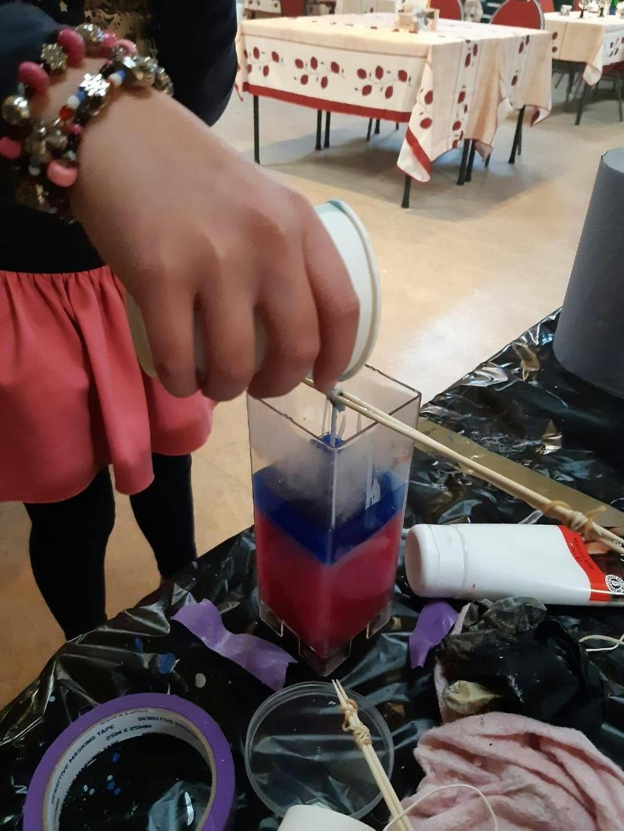 a person holding a straw in a drink on a table