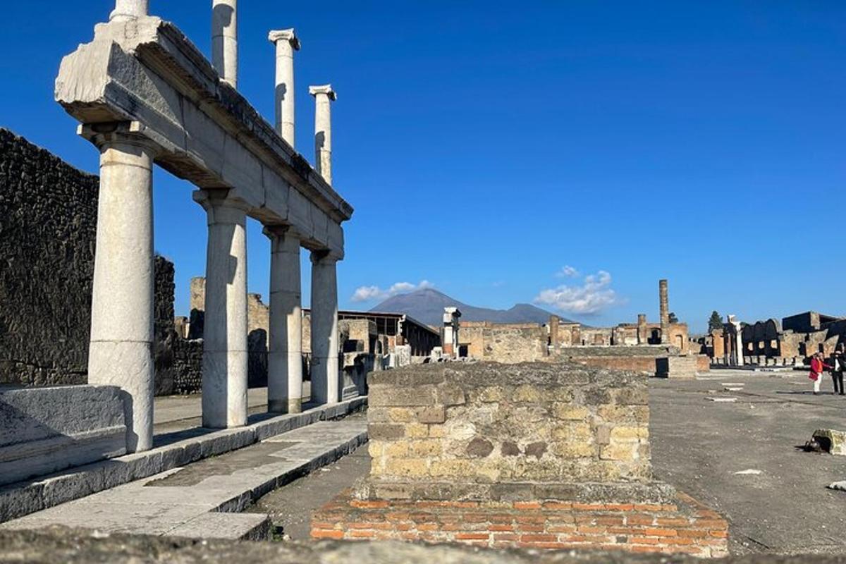 ancient ruins of a building with columns on a street