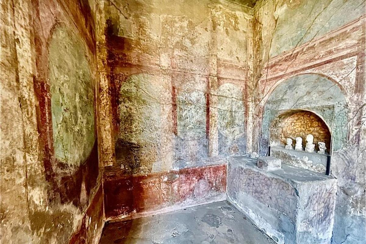 an old room with a stone wall with a sink