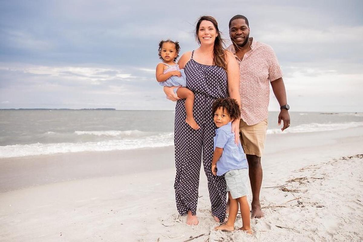 a family posing for a picture on the beach