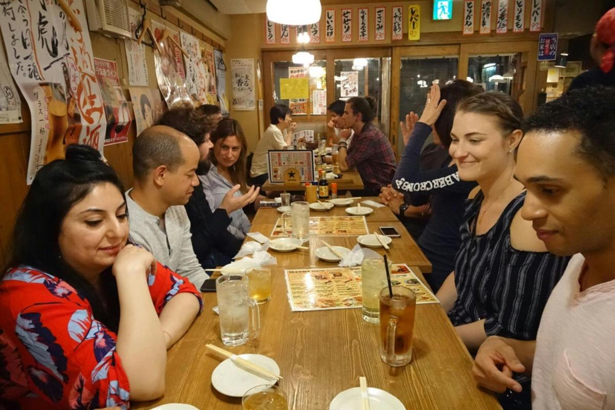 a group of people sitting at a table in a restaurant