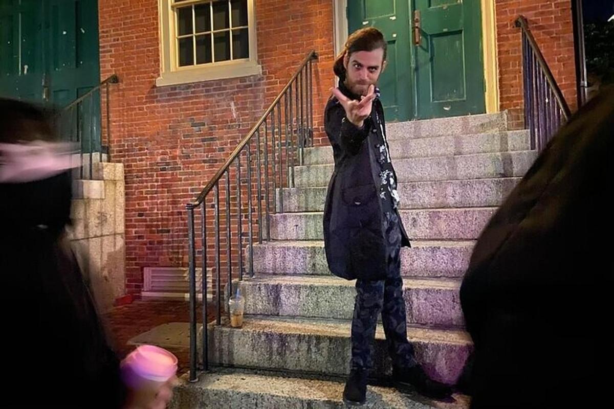 a man standing on the stairs talking on his cell phone