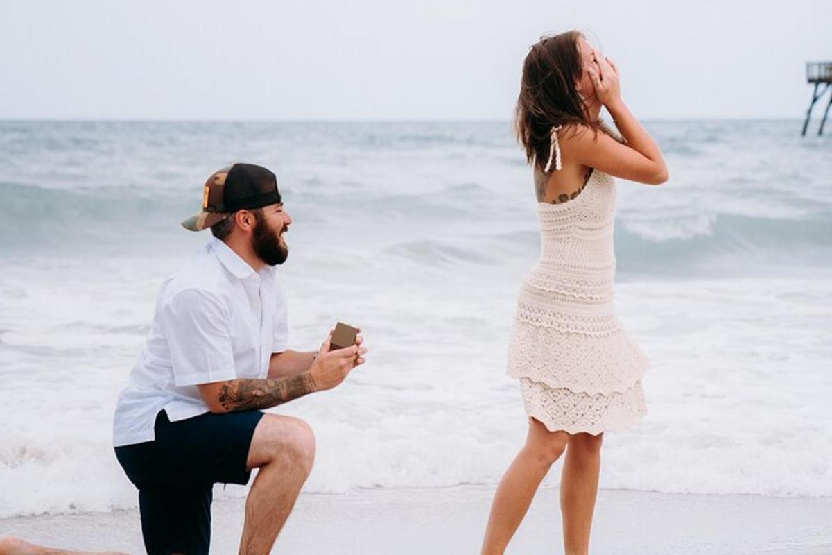 a man and a woman standing on the beach