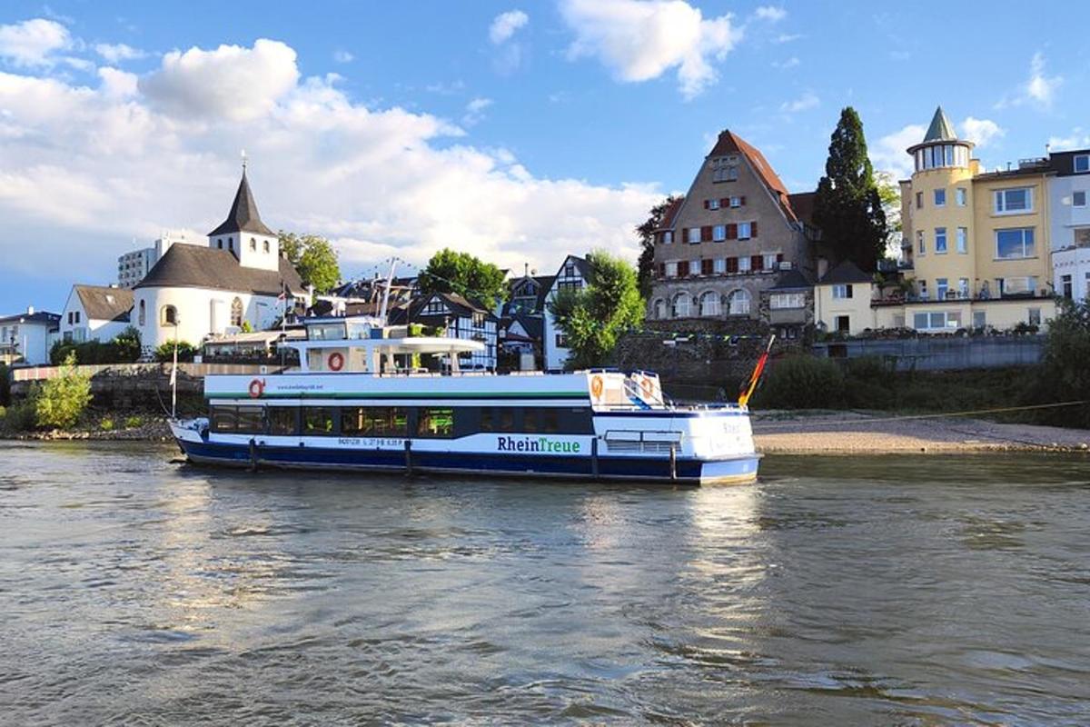 a blue and white boat on a river with buildings