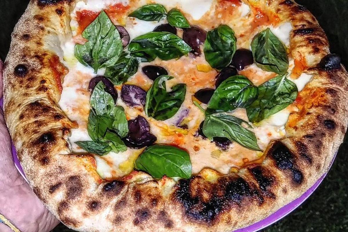 una pizza amb fulles verdes en un plat morat