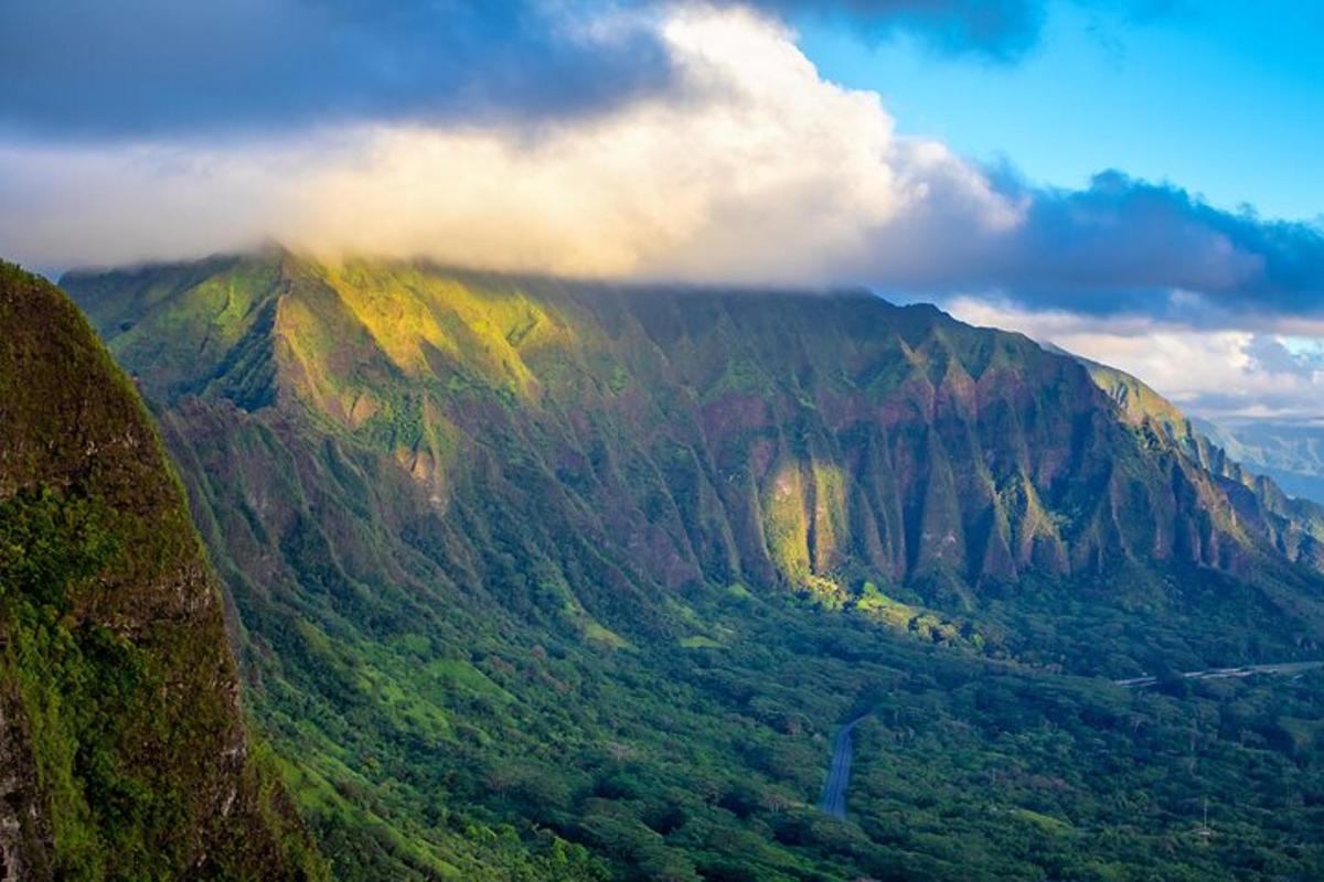 a view of a large mountain with clouds on it