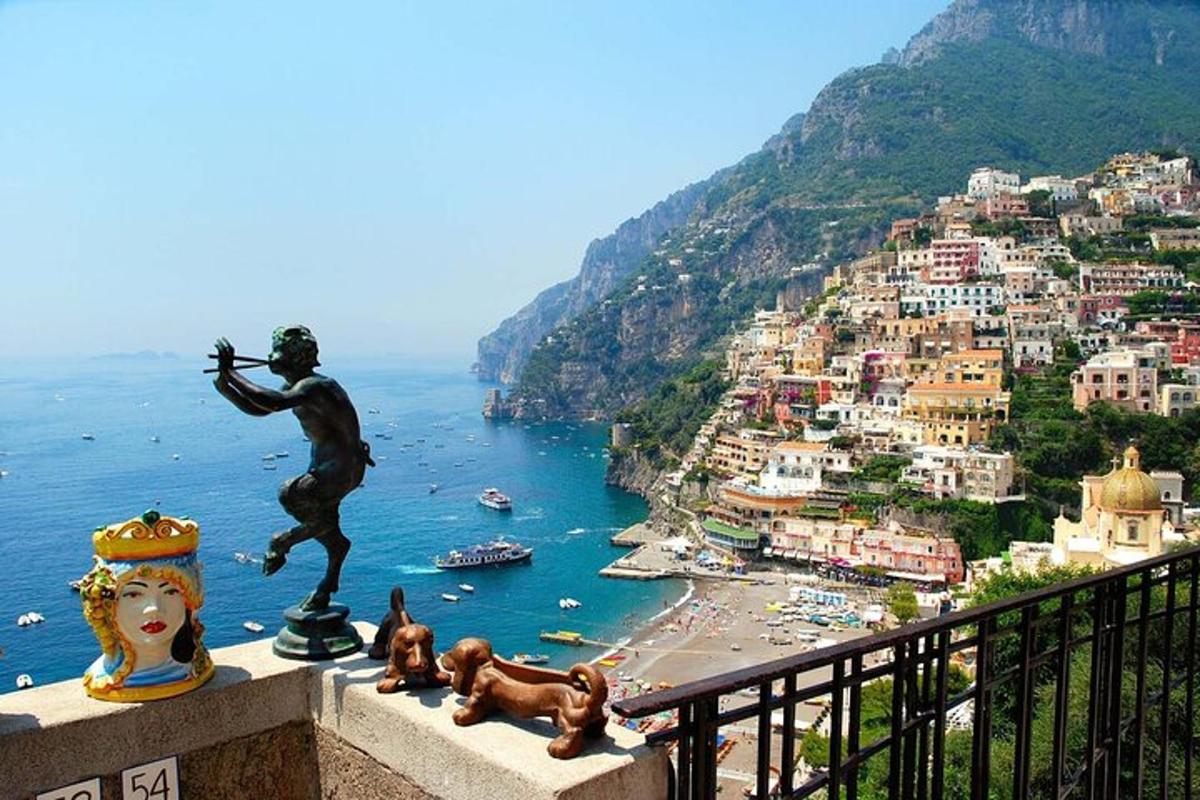 a statue of a man on a ledge overlooking a city