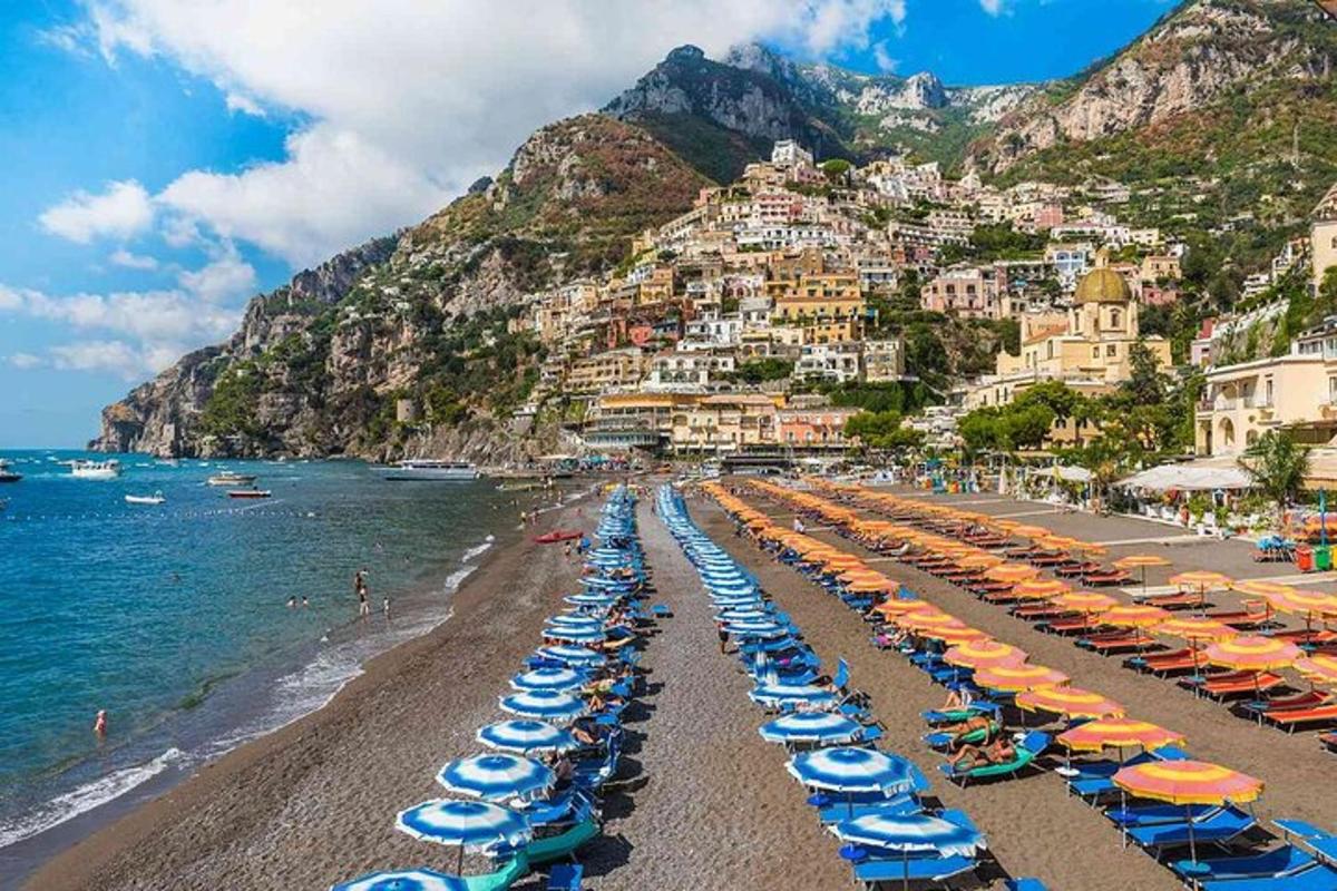 a beach with chairs and umbrellas and the ocean