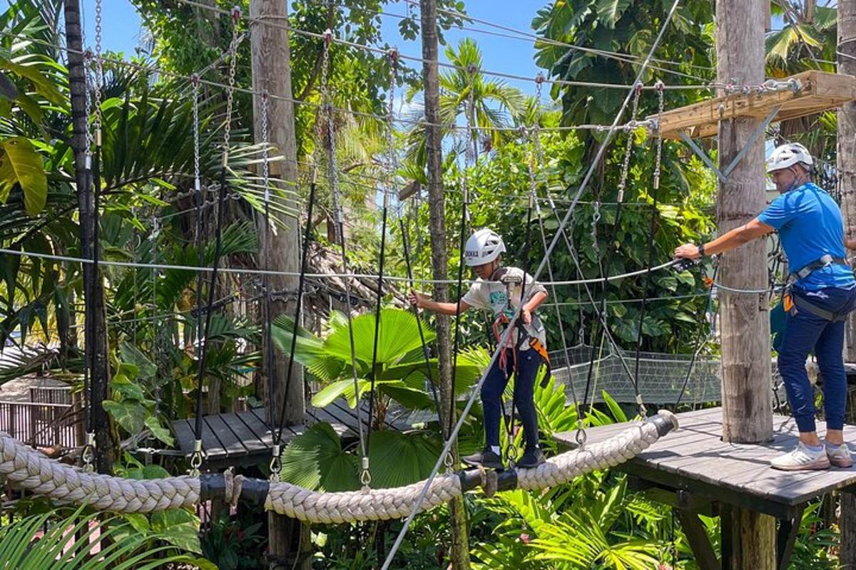 two people on a rope bridge in the jungle