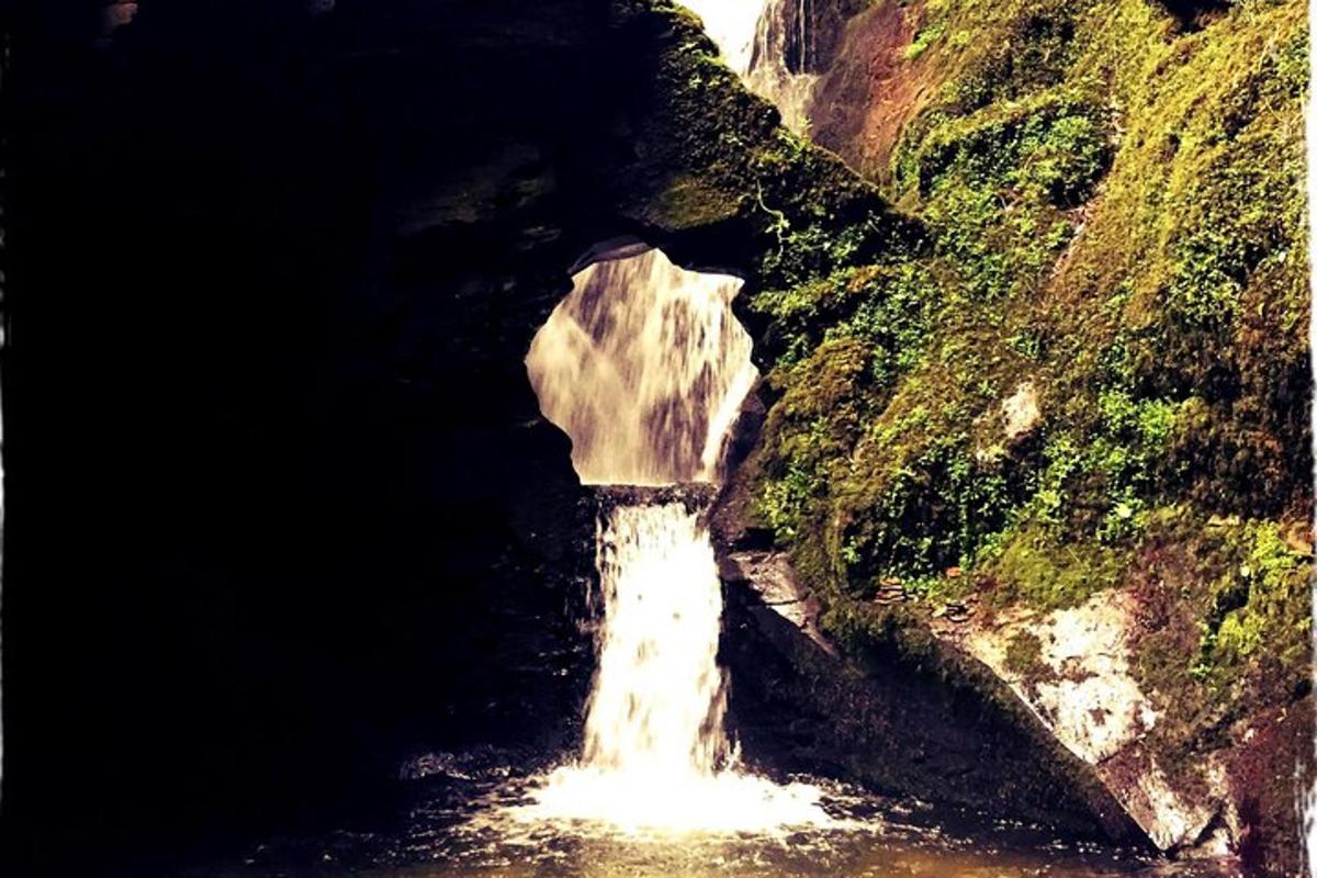 a small waterfall in the middle of a river