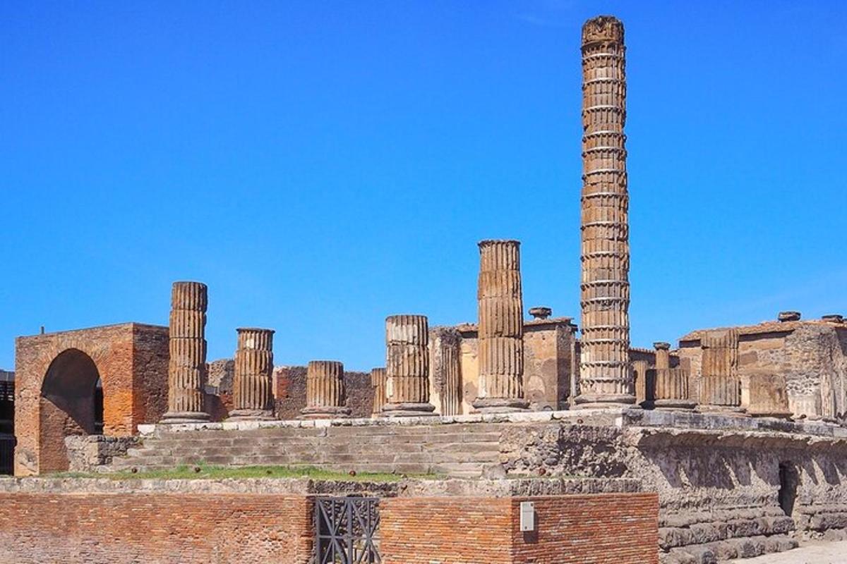 an ancient building with columns and a blue sky