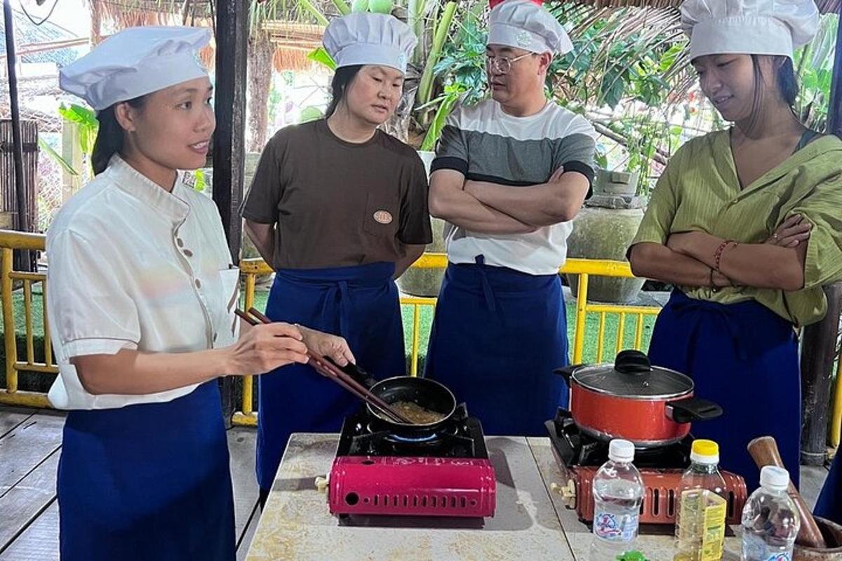 a group of people standing around a stove in a kitchen