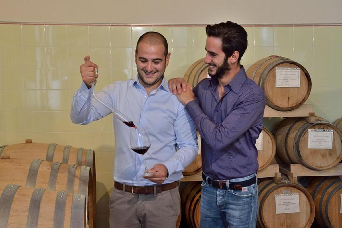 two men are holding up a glass of wine