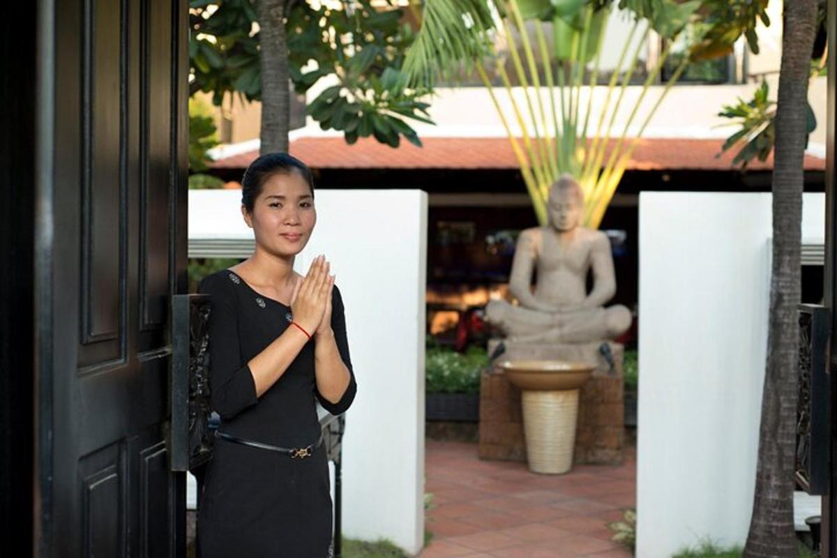 a woman standing in front of a building with a statue