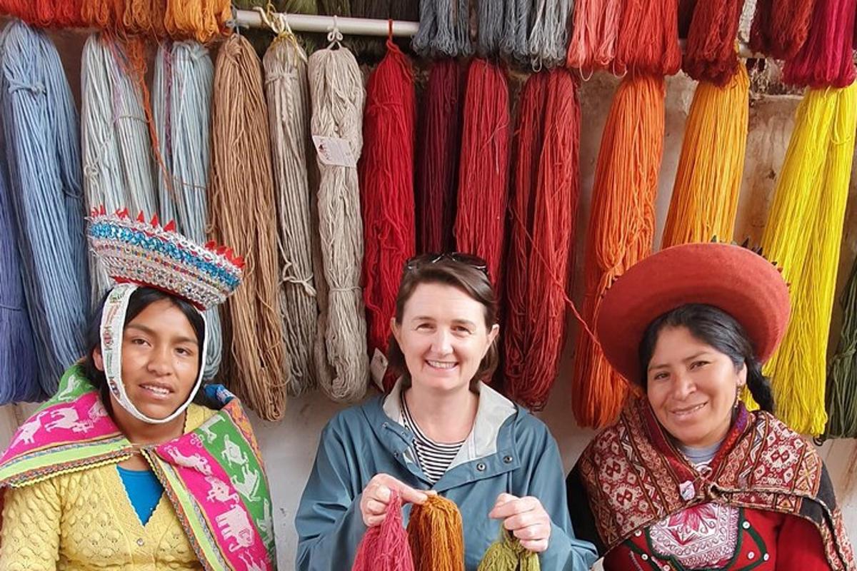 three women standing in front of a display of yarn