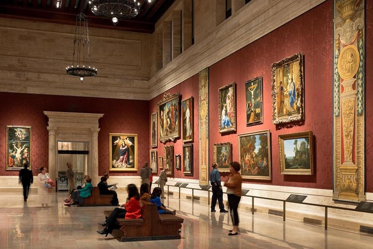people in a museum with paintings on the walls
