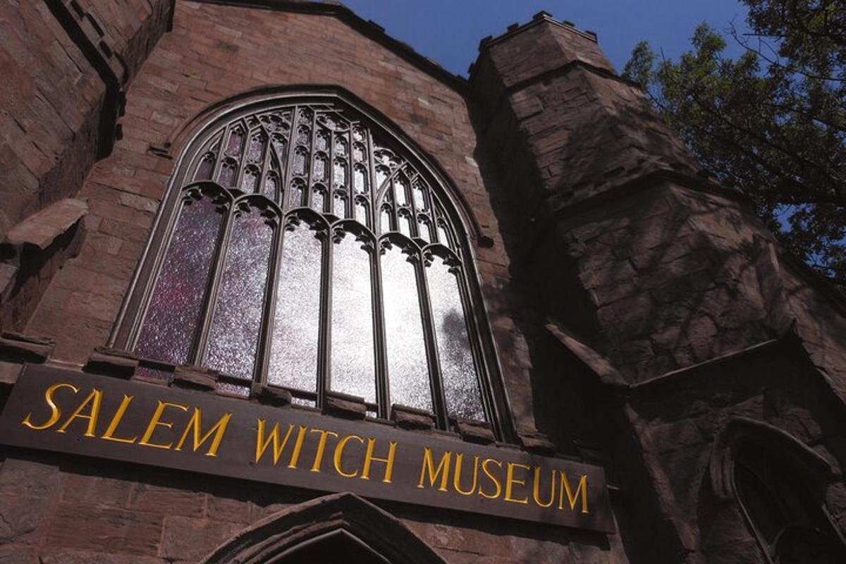a church with a window and a sign in front