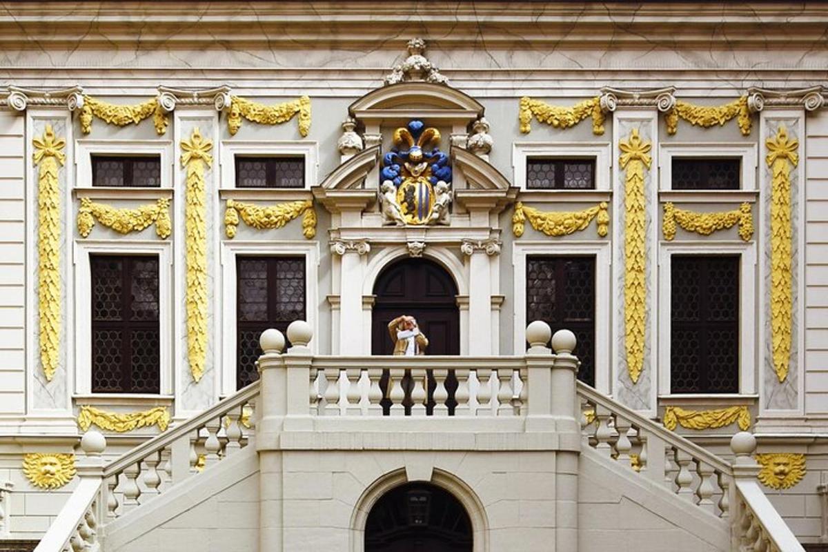 a woman standing on the balcony of a building